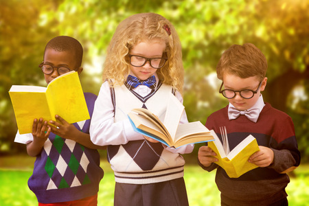 School kids against trees and meadow in the parkの写真素材