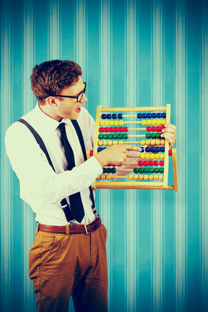 Geeky businessman using an abacus against blue backgroundの写真素材