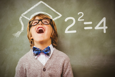 Two squared against boy laughing in front of blackboardの写真素材