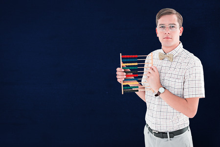 Geeky hipster holding an abacus against navy blueの写真素材