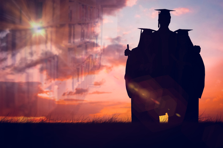 Full length of three friends graduate from college together against orange and blue sky with cloudsの写真素材