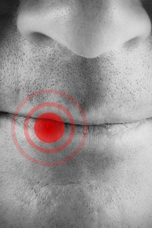 Close up of serious man against highlighted painの写真素材