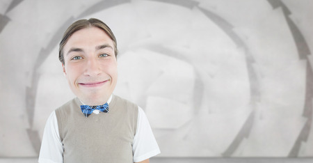 Nerd smiling against sheet spiral on grey wallの写真素材