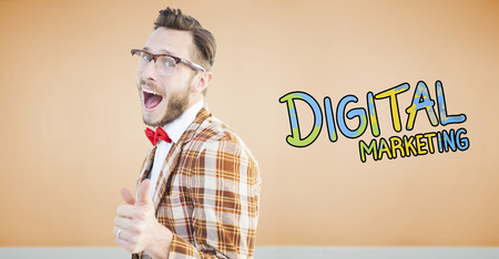 Geeky hipster pointing at camera against room with wooden floor