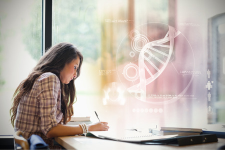 Illustration of DNA against gorgeous student workingの写真素材