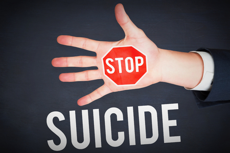 Hand with fingers spread out against blackboardの写真素材