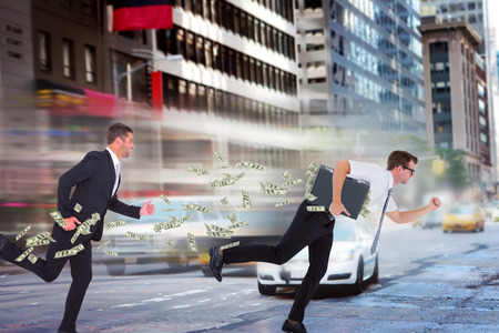 Running businessman against new york streetの写真素材