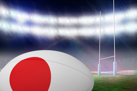 Japanese flag rugby ball against rugby pitchの写真素材