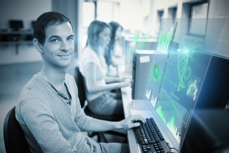 Digital representation of pie chart against smiling male student posing with a computer