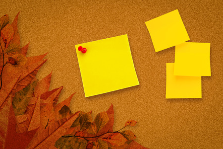 Sticky note against autumn leaves patternの写真素材