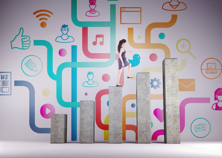 Businesswoman stepping up against bar chart depicting growthの写真素材
