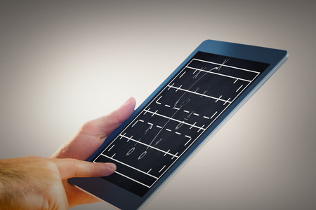 Man using tablet pc against rugby tactics