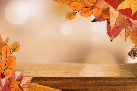 Autumn leaves pattern against overhead of wooden planksの写真素材