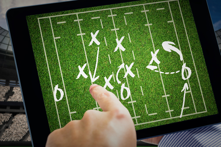Man using tablet pc  against rugby tacticsの写真素材