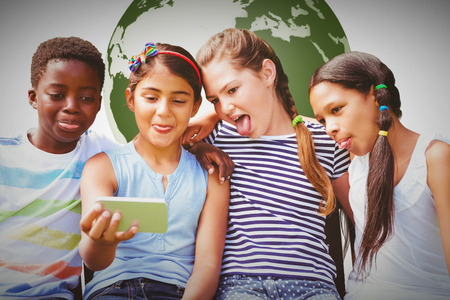 Happy children taking selfie at park against white background with vignetteの写真素材