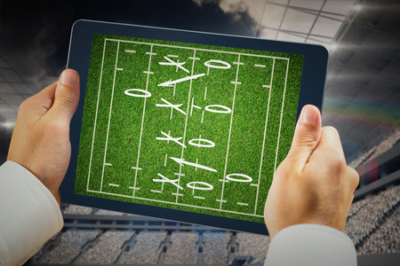 Man using tablet pc against rugby tacticsの写真素材