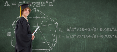 Profile view of a student in graduate robe against green chalkboardの写真素材