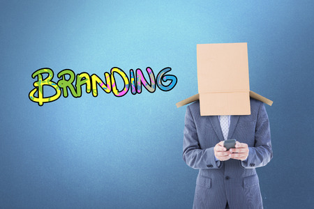 Anonymous businessman using phone against purple vignetteの写真素材