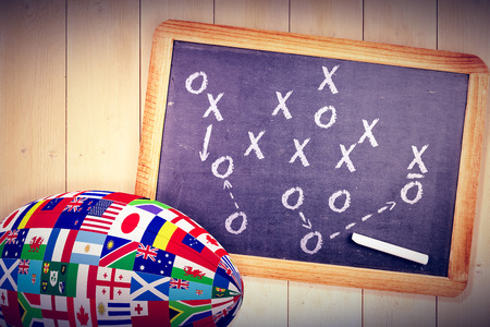 Rugby tournament international ball against chalkboard with piece of chalkの写真素材