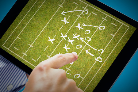 Man using tablet pc  against rugby tacticsの写真素材