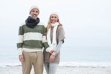 Cute couple standing together at the beachの写真素材