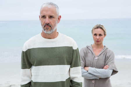 Woman angry at her partner at the beachの写真素材