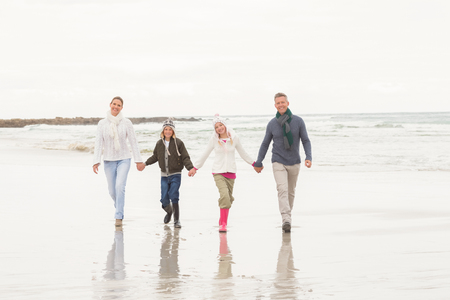 Happy family enjoying a nice day out at the beachの写真素材