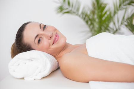 Happy woman in a bed in medical officeの写真素材