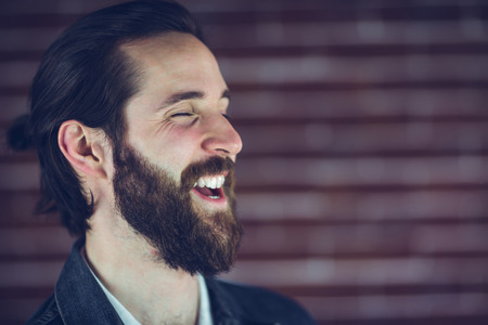 Cheerful hipster against wallの写真素材