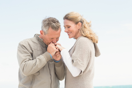 Happy couple holding each other at the beachの写真素材