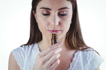 Pretty woman taking alternative tincture on white backgroundの写真素材