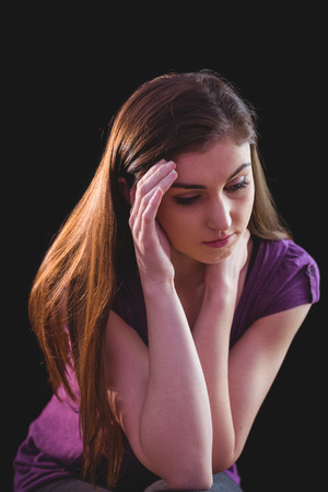 Unhappy woman thinking on black backgroundの写真素材
