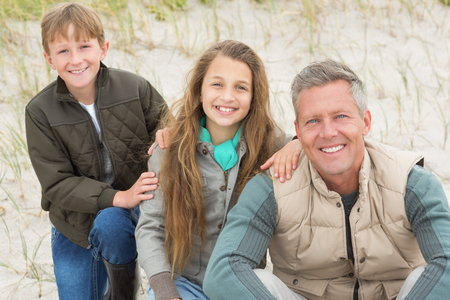 Father and kids enjoying a day out at the beachの写真素材