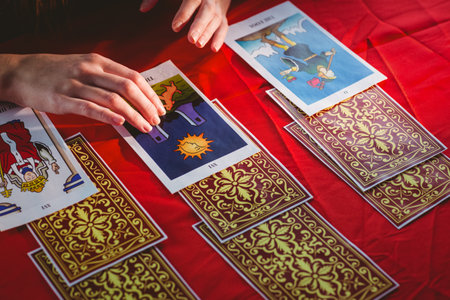 Fortune teller using tarot cards on red tableのeditorial素材