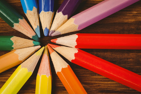 Colour pencils on desk in circle shape shot in studio