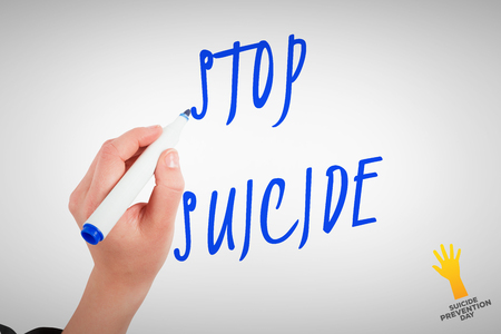 Businesswomans hand writing with marker against suicide prevention dayの写真素材
