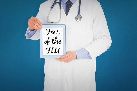 Doctor showing a digital tablet against blue backgroundの写真素材