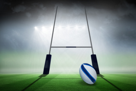 Rugby ball against rugby pitchの写真素材