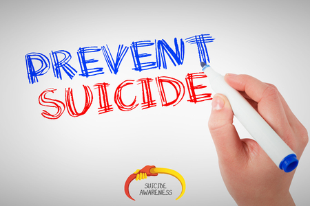 Businesswomans hand writing with marker against suicide awarenessの写真素材