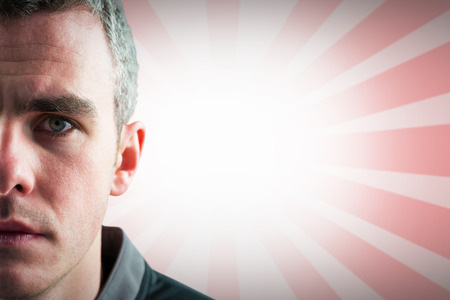 A rugby player looking at the camera against linear design