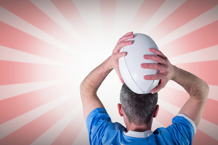 Rugby player about to throw a rugby ball against linear designの写真素材