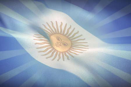 Close-up of Argentina flag waving against blue backgroundの写真素材