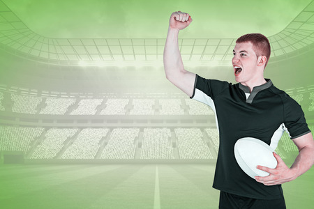 A rugby player gesturing victory against green vignetteの写真素材