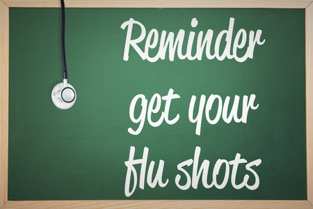 Flu shot reminder against stethoscopeの写真素材