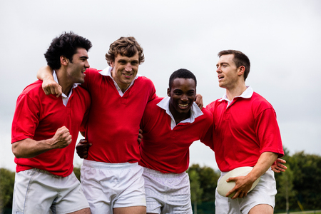 Rugby players putting hands together at the parkの写真素材