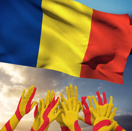 People raising hands in the air against blue sky with cloudsの写真素材