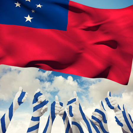 Group of hands giving thumbs up against blue sky with cloudsの写真素材