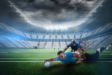 A rugby player scoring a try against rugby stadiumの写真素材