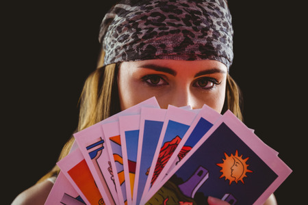Fortune teller using tarot cards on black backgroundの写真素材