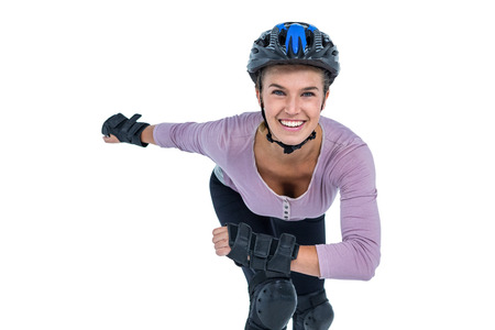 Portrait of cheerful young woman skating over white background